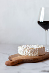 Camembert cheese served with a glass of wine
