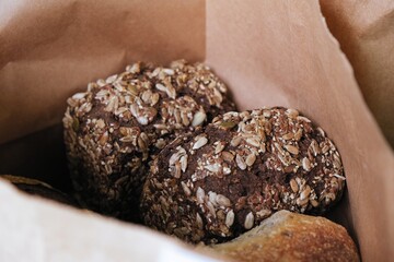 freshly baked bread in craft bags. Home baked whole grain bread. Crusty sourdough loaf of wheat bread with wholegrain flour.	