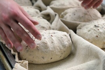 baker at work. The baker shapes the bread. Hands on the close-up form bread