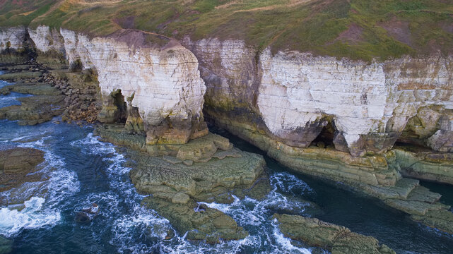 An image of the cliff face at North Landing in East Yorkshire, UK. This image shows how the sea has eroded the cliff to form caves.