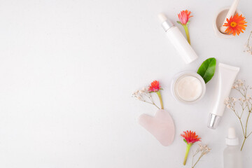 skincare and cosmetic product on white background with flower. Beauty and lifestyle concept with copy space, flatlay. 