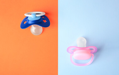 Baby pacifiers on color background, flat lay