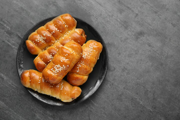 Delicious sausage rolls on grey table, top view. Space for text