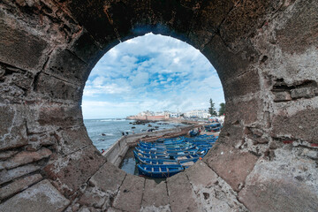 Breathtaking view of the fishing port of Essaouira (Morocco) through a hole in the fortress wall - Mogador -