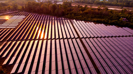 Photovoltaic solar panels at sunrise and sunset.Solar panel cell on dramatic sunset sky background,clean Alternative power energy concept.