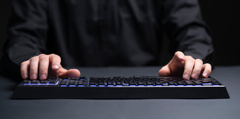 person on his work place typing on the keyboard