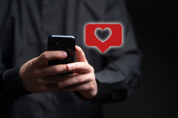 person holding a smartphone and receive the like in social network