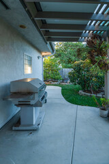 Backyard patio with barbecue grill.