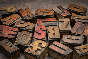 alphabet abstract in vintage letterpress wood type printing blocks (mirror image) against handmade...