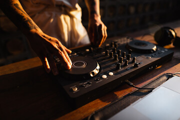 DJ playing music,Man using mixing desk at party out in the evening