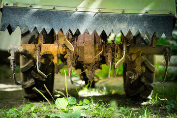 Rototiller of a walk-behind tractor close-up. Agricultural machinery for processing and care of the...