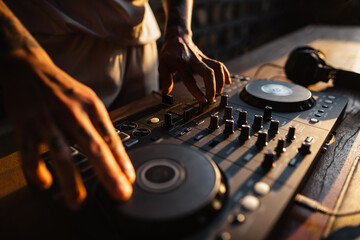 DJ playing music,Man using mixing desk at party out in the evening