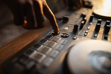 DJ playing music,Man using mixing desk at party out in the evening