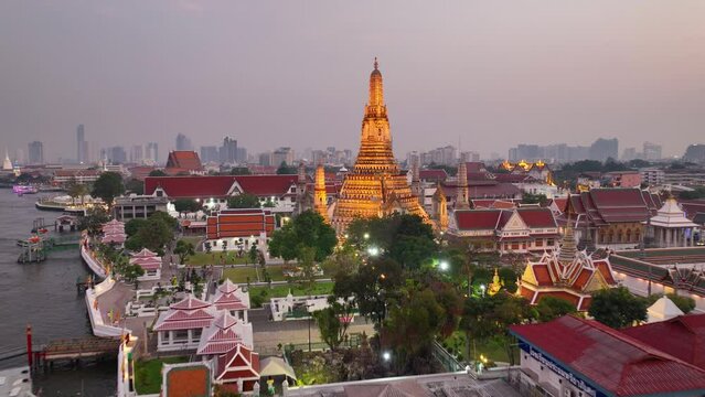 aerial view of Wat Arun temple in Bangkok, capital of Thailand, illuminated traditional Thai Buddhist temple of War Arun at sunset