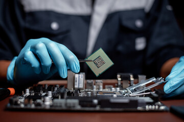 Technician under fixed and repairing computer process CPU chip for analysis and maintenance on computer mainboard is electronic component concept.