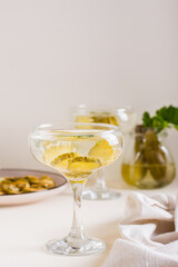 Cocktail with pickles in glasses on the table. Homemade drinks. Vertical view