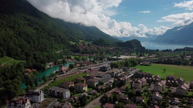Small city in the swiss Alps of Bernese Oberland. Opening shot slow dolly flight over the roofs of Interlaken