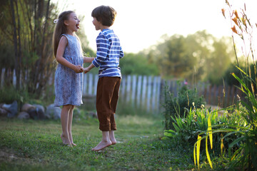 Children walk in the summer in nature. Child on a sunny spring morning in the park. Traveling with children.