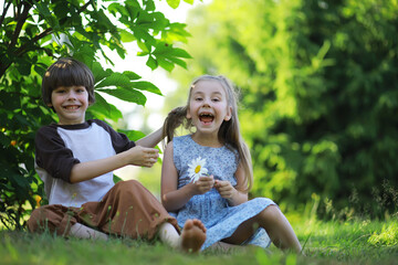 Children walk in the summer in nature. Child on a sunny spring morning in the park. Traveling with children.