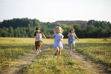 Children walk in the summer in nature. Child on a sunny spring morning in the park. Traveling with...