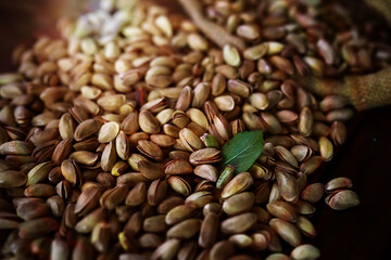 Roasted salted pistachios. Dried pistachios in small sack on  table.
