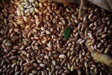 Roasted salted pistachios. Dried pistachios in small sack on  table.