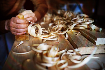 Hand planer with wooden sawdust. On a wooden background. High quality photo