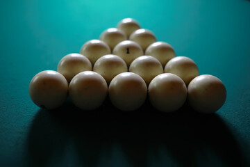 Russian billiard balls, cue, triangle, chalk on a table Green cloth Copy space