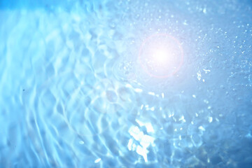 Bubbles and seething water in the light of sunlight.Blue water texture.
