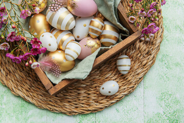 Easter decor. Colored Easter eggs in a wooden box on the table.
