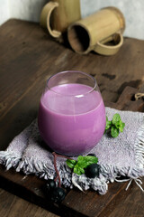 Obraz na płótnie Canvas blueberry-flavored collagen drink with a minimalist photo concept of bright mood and darkmood