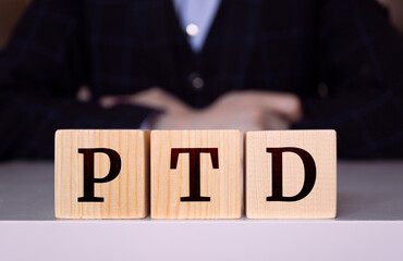 The word "PTD" written on wood cube. PTD - short for Project To Date acronym