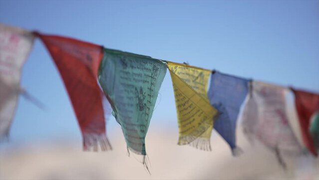 Lungta Prayer flags flying in the wind on blur blue background at LEH LADAKH , INDIA 