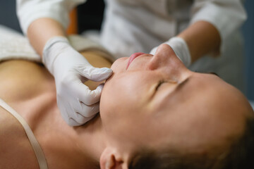 Woman lay down in cosmetology beauty clinic