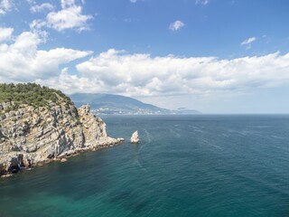 aerial photo of rock Parus Sail and Ayu-Dag Bear Mountain and near Gaspra, Yalta, Crimea at bright sunny day over the Black sea. Rock Parus in Gaspra near Swallow's nest in Crimea. - obrazy, fototapety, plakaty