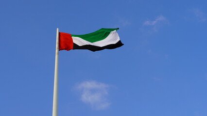 United Arab Emirates National flag against blue sky. Flag day, National day of UAE