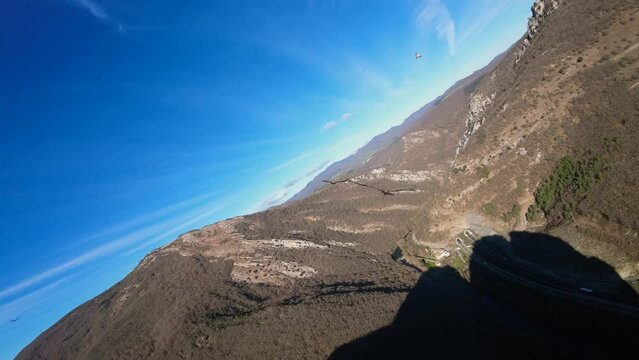 Impressive image of a first-person drone flying above two vultures and seeing their maneuvers close up. Image taken in the Navarra mountain on a sunny day. Action image.