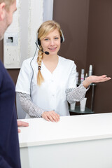 a female receptionist welcoming patient