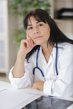 mature female doctor looking at camera