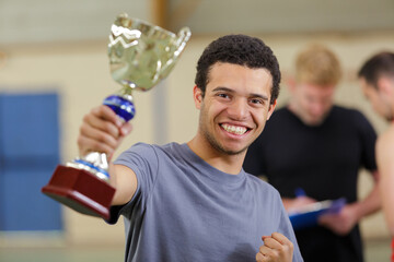 man with a trophy in a sport competition