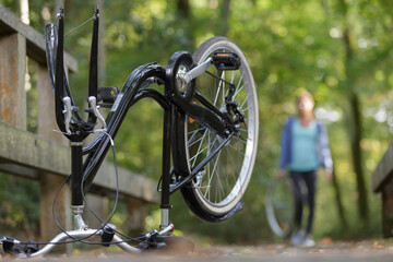 Fototapeta na wymiar woman and a broken bike outdoors