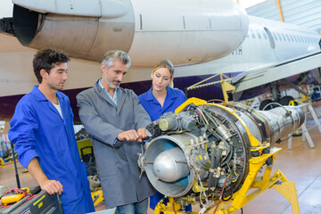 aviation technician studying a part