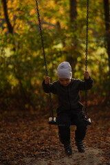 Kid bungee jumping in the summer forest