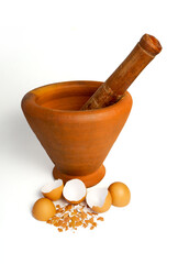 Mortar and pestle on white background with eggshell