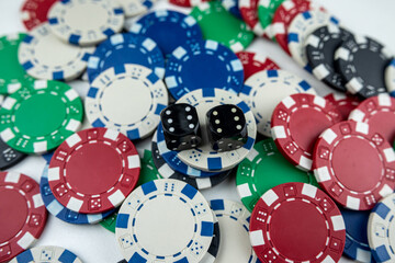 Two black dice on poker chips, top view. Casino concept