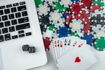 Business online poker games with laptop two black dice playing card and casino chips