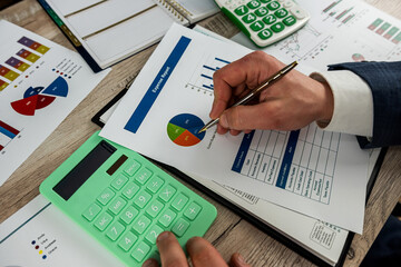 Fototapeta na wymiar Business man using calculator for accounting finance chart and diagram