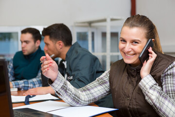 portrait of female worker using smartphone in office