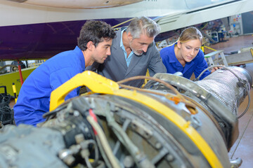 Engineers looking at aircraft component