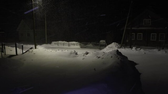 Night snow storm in countryside of cold region in winter.